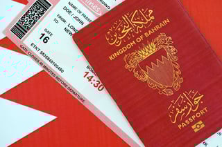 Bahrain passport placed on travel ticket