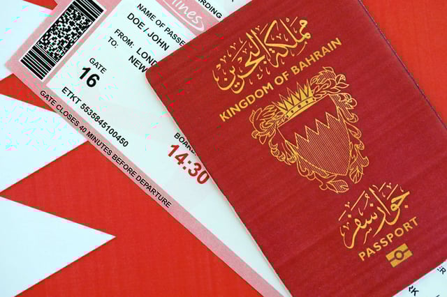 Bahrain passport placed on travel ticket