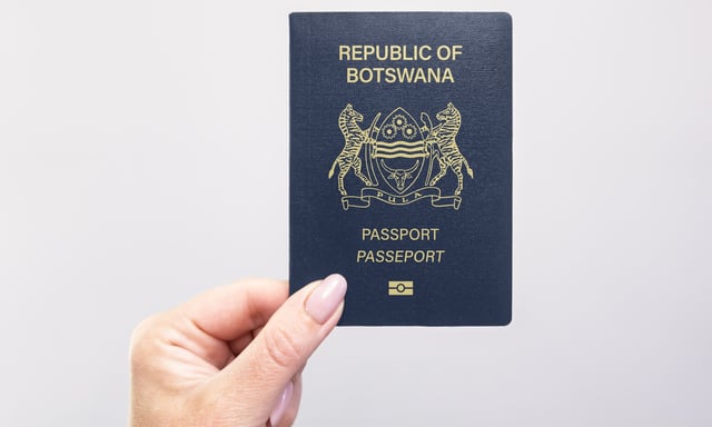 Hand Holding the Passport of Botswana