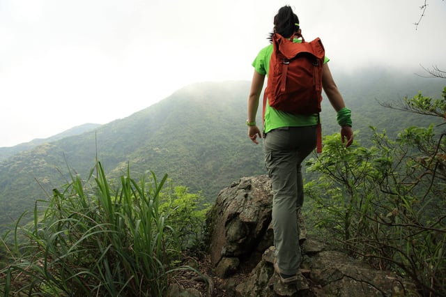 Young woman hiker on mountain peak
